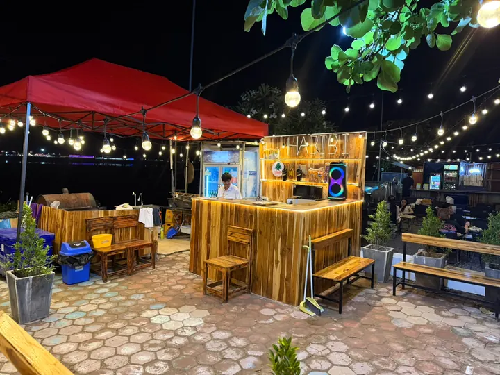 The wooden Habibi bar with its glowing sign and drinks fridge
