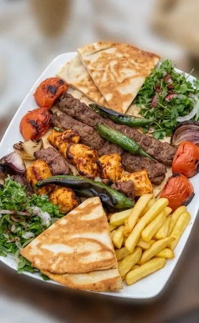 Small Mixed Grill Platter with grilled chicken, beef and lamb, fries, sumac salad and pita